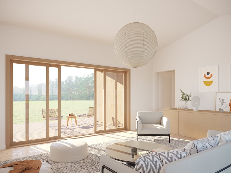 May include: A bright, airy living room with a large sliding glass door leading to a deck. The room features a white sofa, armchair, and a round paper lantern. A wooden cabinet and abstract art complete the modern interior.