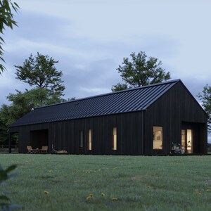 May include: A modern, black-clad house with a dark metal roof sits on a grassy lawn. The house has large windows and a covered porch area. Trees and a fence are visible in the background, under a cloudy sky.