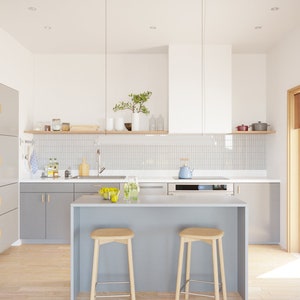 May include: Modern kitchen with gray cabinets, a white range hood, and a light gray island with two wooden stools. A wooden shelf displays jars and vases. The kitchen has a light wood floor and a window with natural light.