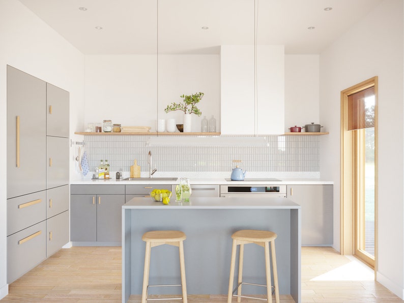 May include: Modern kitchen with gray cabinets, a white range hood, and a light gray island with two wooden stools. A wooden shelf displays jars and vases. The kitchen has a light wood floor and a window with natural light.