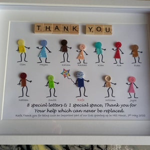 May include: A framed artwork with the words "THANK YOU" spelled out in wooden tiles. The artwork features a colourful design with felt figures and buttons, representing children. The text below the figures reads "8 special letters & 1 special space, Thank you for Your help which can never be replaced. Rafa, Thank you for being such an important part of our lives growing up in Hill House, 7th May 2022."