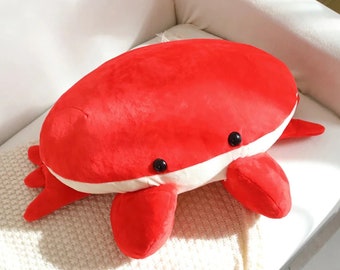 Oreiller en peluche animal marin simulant un crabe de pain rouge.