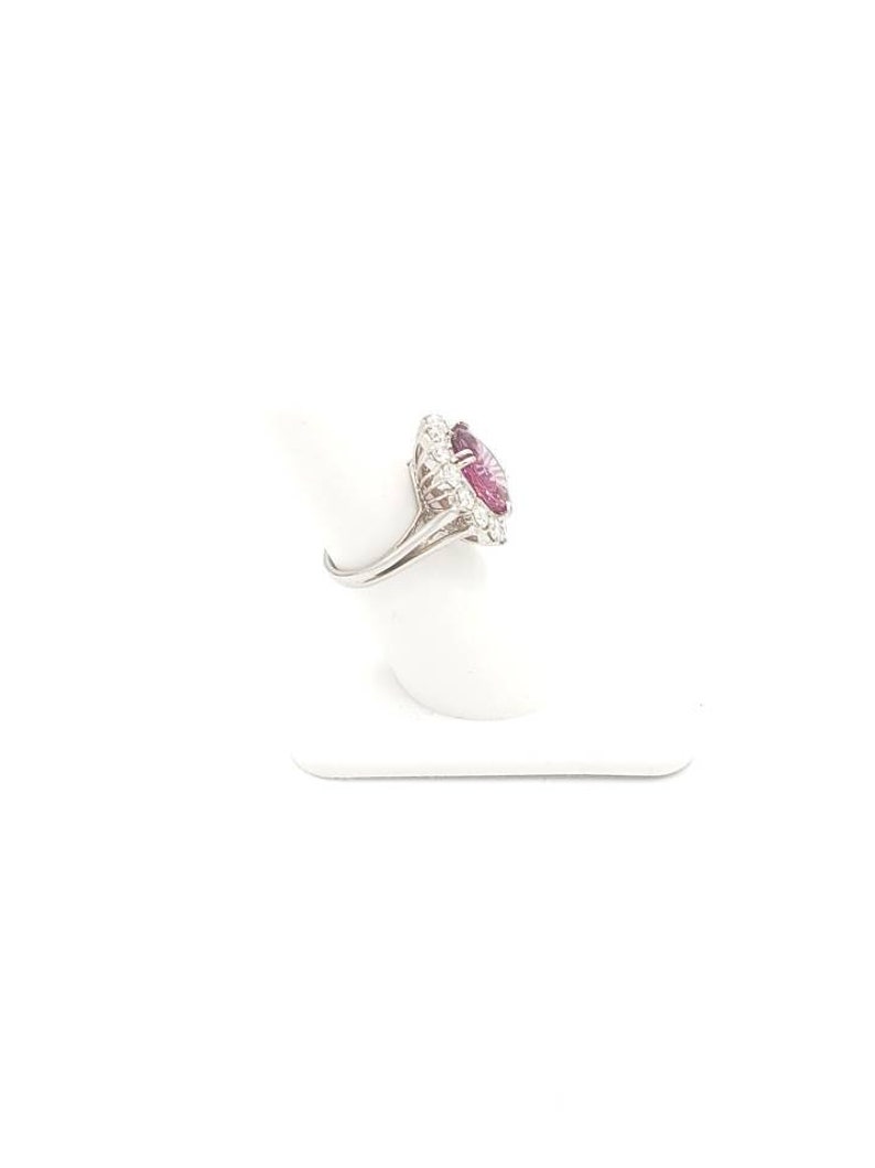 May include: A silver ring with a large pink gemstone surrounded by smaller white gemstones.