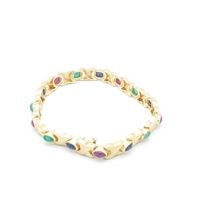 May include: A gold bracelet with a chain link design featuring alternating oval-shaped gemstones in shades of green, blue, and red.