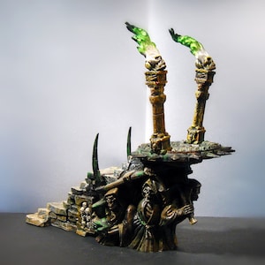 May include: A miniature, hand-painted, fantasy-themed, skeletal figure with a green flame atop a stone staircase. The figure is wearing a dark robe and holding a staff. The staircase is decorated with skulls and bones.