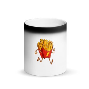 May include: A white ceramic mug with a black rim. The mug has a color-changing design that reveals a cartoon image of a running box of french fries with a lightning bolt on the side when hot.