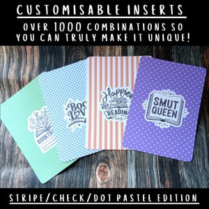 May include: Four rectangular card inserts with rounded corners featuring pastel patterns including solid mint green, blue checkered, orange striped, and purple polka dot. Each card displays a white sticker with black text reading BOOKTROVERT, BOOK LOVER, HAPPIER WHEN READING, and SMUT QUEEN.