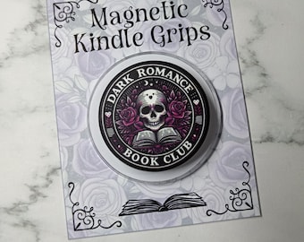 Puede incluir: Un agarre magnético circular para Kindle con un gráfico de una calavera sobre un libro abierto rodeado de rosas moradas. El texto dice Dark Romance Book Club. Está montado en una tarjeta rectangular con patrón de rosas y el texto Magnetic Kindle Grips.