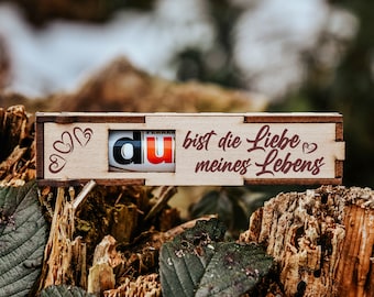 May include: A wooden box with a sliding drawer that says "du bist die Liebe meines Lebens" (You are the love of my life) in German. The box is decorated with hearts.