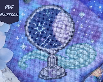 May include: A cross-stitch pattern of a glass orb with a crescent moon and stars inside. The orb is on a blue and purple background with a swirling design.