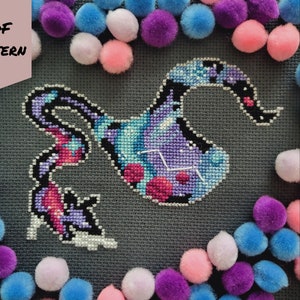 May include: A cross-stitch pattern of a purple and blue celestial creature with stars and a constellation. The pattern is surrounded by colourful pom-poms and the text "PDF PATTERN" and "BAD Stitch" are visible.