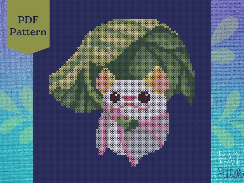 May include: Cross stitch pattern featuring a white animal with pink ears and a green leaf on its head. The animal is wearing a pink ribbon and is under a large green leaf. The pattern is on a blue background.