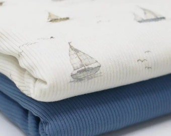 May include: Two pieces of fabric, one white with a sailboat pattern and the other a solid blue. Both fabrics have a ribbed texture.