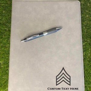 May include: A gray leatherette folder with a black chevron design and the text "CUSTOM TEXT HERE".