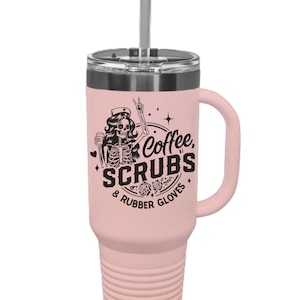 May include: A light pink insulated tumbler with a handle and a silver straw. The tumbler features a black graphic of a skeleton nurse with the words "Coffee, Scrubs & Rubber Gloves."