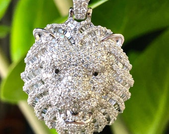 May include: A silver lion pendant with a detailed design, completely covered in sparkling white diamonds.