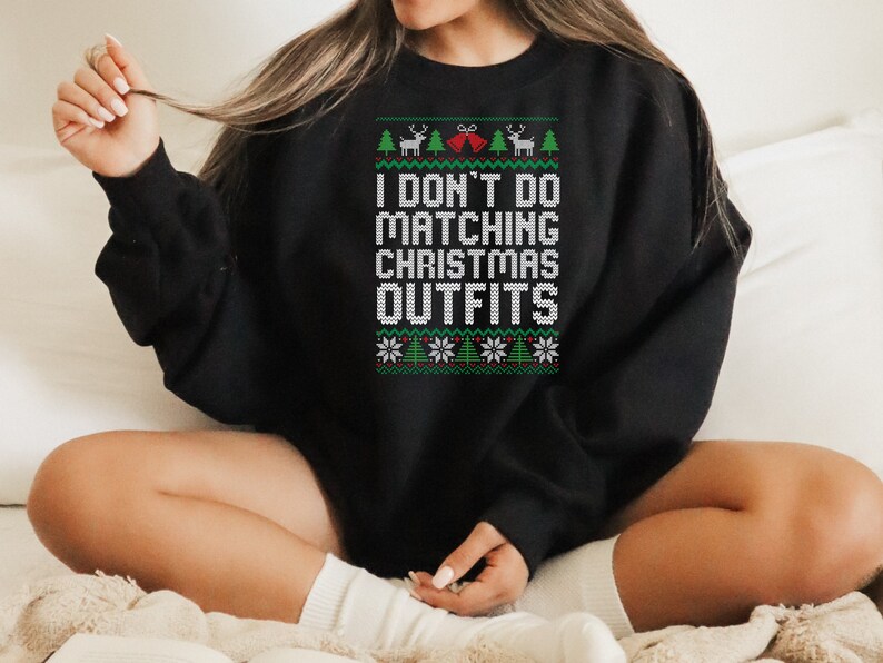 May include: Black Christmas sweater with a white design that says "I don't do matching Christmas outfits".