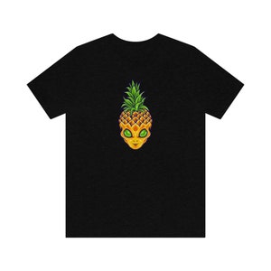 May include: Black t-shirt with a graphic of an alien head with a pineapple for hair.