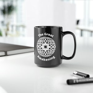 May include: Black ceramic coffee mug with a white design of a circle with a star in the center and the text "The Great Awakening".