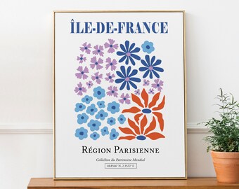 May include: A white poster with a blue and orange floral design. The poster has the text "ÎLE-DE-FRANCE RÉGION PARISIENNE Collection du Patrimoine Mondial 48.8566 N. 2.3522" E