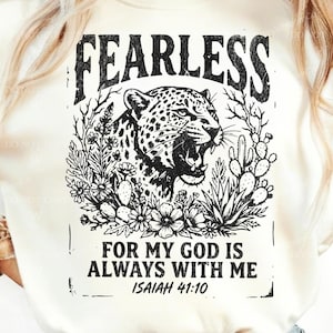 May include: Cream-colored t-shirt with a black graphic design. The design features the word "FEARLESS" above a leopard illustration surrounded by plants. Below the leopard, the text reads "FOR MY GOD IS ALWAYS WITH ME ISAIAH 41:10".