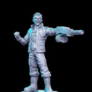 May include: A gray plastic figurine of a person wearing a jacket and holding a large gun. The figurine is standing on a gray base.