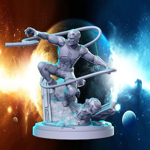May include: A gray 3D printed figurine of Daredevil, a superhero from Marvel Comics, standing on a rocky base. He is holding a billy club and is in a fighting pose. The figurine is set against a backdrop of a blue and orange nebula.