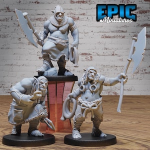 May include: Three gray painted miniature figures of orcs, each with a different weapon and pose. The orcs are standing on black bases. The orcs are from the Epic Miniatures line.