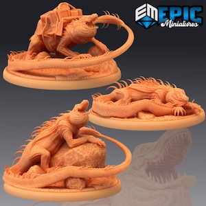 May include: Three 3D printed miniature lizard figures, each with a different pose. The first lizard is curled up with its tail in its mouth, the second lizard is standing on its hind legs with its tail curled around its body, and the third lizard is lying on its belly with its tail curled around its body.