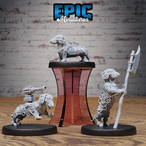 May include: Three miniature dachshund figurines, each with a different steampunk design. One dachshund is holding a weapon, another is riding a tank, and the third is standing on a pedestal. The figurines are painted in a gray color and are made of plastic.