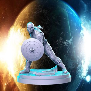 May include: A white painted figurine of a superhero holding a shield in front of them. The figurine is posed in a dynamic action pose. The background is a blurry image of a planet.