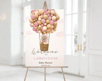 Puede incluir: Bienvenido a la baby shower de Lauren Oliver cartel con un oso de peluche rosa y marrón en un globo aerostático hecho de globos rosas y marrones. El cartel dice "Bienvenido a la baby shower de Lauren Oliver 30 de junio de 2022".