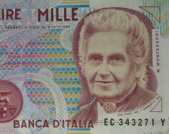 May include: A 1000 Lire Mille Italian banknote featuring a portrait of Maria Montessori, an Italian physician and educator. The banknote is printed in red, blue, and green with a geometric pattern. The text "OFFICINA DELLA BANCA D'ITALIA" is printed on the left side of the banknote. The text "1000 LIRE MILLE" is printed in large font at the top of the banknote. The text "PAGABILI A VISTA AL PORTATORE" is printed below the denomination. The text "BANCA D'ITALIA" is printed at the bottom of the banknote.