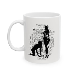 May include: White ceramic mug with a black silhouette of a woman and a kneeling figure, and words such as "Mistress", "Slave", and "Domme" in a word cloud design. The mug has a curved handle.