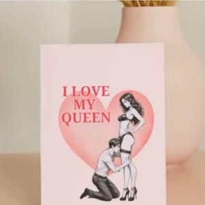 May include: A greeting card with the text "I LOVE MY QUEEN" in red letters. The card features an illustration of a woman in lingerie and a man kneeling before her, set against a pink heart.