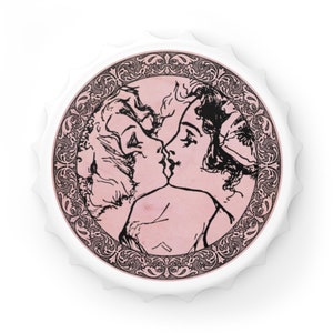 May include: A white bottle cap with a pink and black illustration of two women kissing. The illustration is surrounded by a decorative border. The bottle cap is round with a crimped edge.