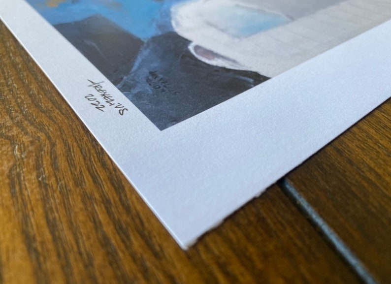 May include: A white paper print with a blue and gray abstract painting. The print is signed "Sarah's Art" and dated "03/22".