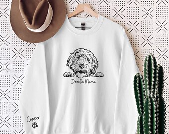 May include: White sweatshirt with a black and white doodle dog illustration and the text "Doodle Mama" printed on the front. The sweatshirt has a paw print with the word "Copper" printed on the left sleeve.