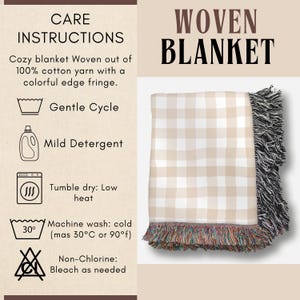May include: Woven blanket with a beige and white checkered pattern. The blanket has a black fringe on one side and a colorful fringe on the other. The care instructions are listed on the left side of the image.