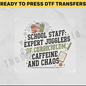 May include: White DTF transfer with the text "SCHOOL STAFF: EXPERT JUGGLERS OF CURRICULUM, CAFFEINE AND CHAOS." The design includes images of soda cans, a clipboard, a pencil, and crumpled paper.