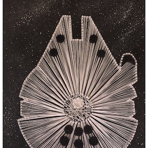 May include: White string art of the Millennium Falcon spaceship on a black background with white glitter. The spaceship is outlined in white string and has black circles for details.