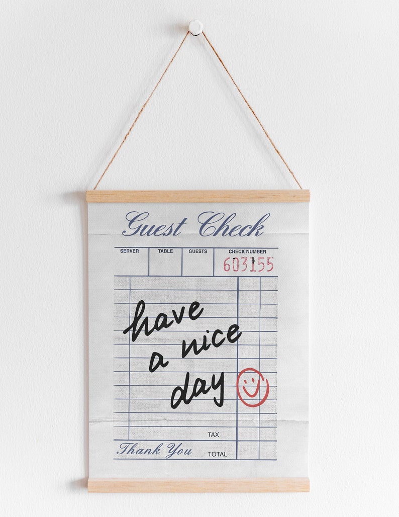 May include: A white guest check with blue text that reads "Guest Check". The check has a black handwritten message that says "have a nice day" with a red smiley face.