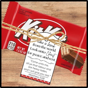 May include: A red Kit Kat candy bar with a decorative twine bow and a white tag. The tag has the text "Take a break from the world. Look unto Christ for peace and rest." and a Bible verse. The candy bar is 1.5 oz.