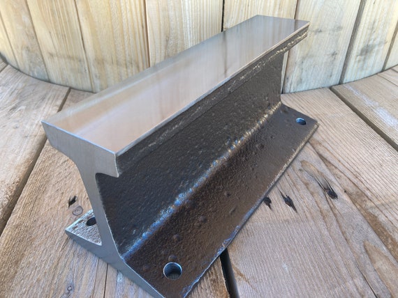 Railroad track anvil with mounting holes