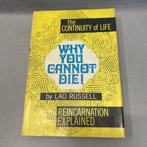 Op de afbeelding: Een geel hardcover boek getiteld The Continuity of Life: Why You Cannot Die! door Lao Russell. De kaft bevat zwarte decoratieve krullen, een wit centraal embleem en de ondertitel Reincarnation Explained in zwarte tekstblokken.