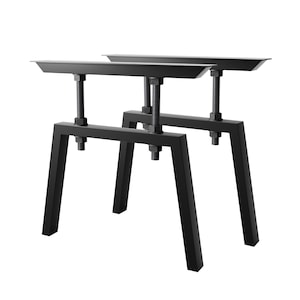 Può includere: Due gambe per tavolo in metallo nero con altezza regolabile. Le gambe hanno una forma a A e un piano superiore piatto.
