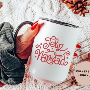 May include: White ceramic mug with a black rim and handle. The mug has red cursive text that says "Feliz Navidad".