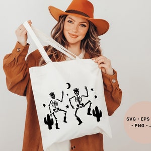 May include: White tote bag with a black design of two skeletons dancing with cacti and a crescent moon. The text "SVG - EPS - DXF - PNG - JPG" is on a pink background.