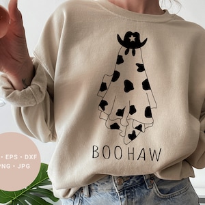 May include: A beige sweatshirt with a black and white cow print ghost wearing a cowboy hat and the text "BOOHAW" printed on the front.
