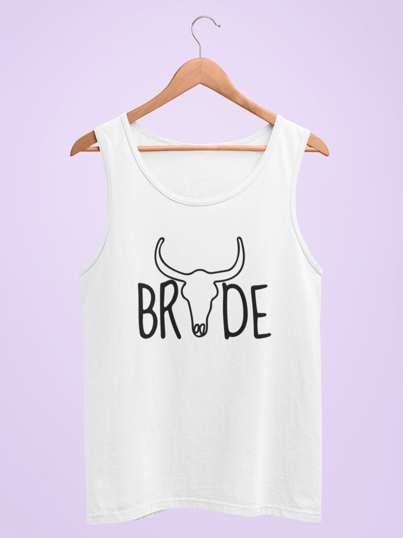 May include: White tank top with a black bull skull graphic and the word "BRIDE" printed below it.